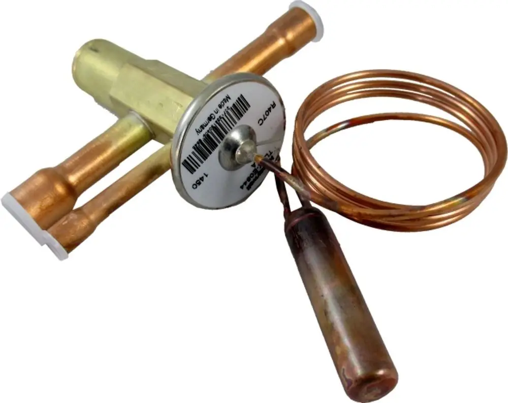 Wolf Expansionsthermometer mit Ventil, bestehend aus Messgerät und Kupferleitungen, zur Verwendung in Heizsystemen.
